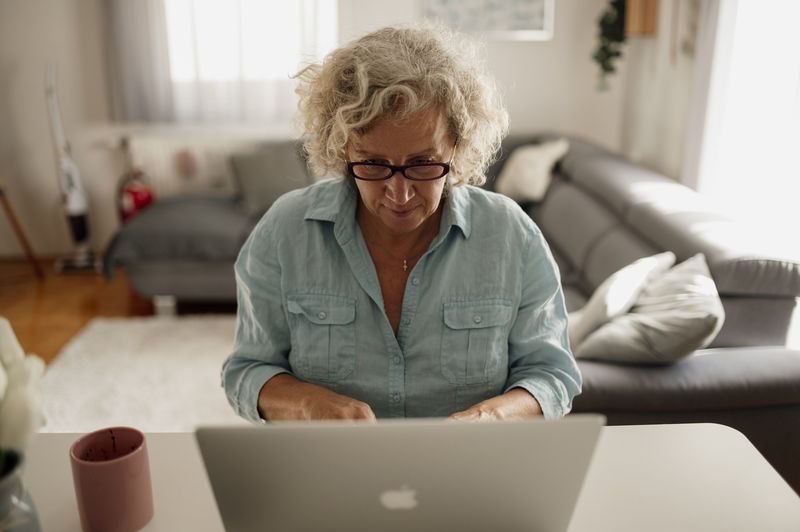 A woman working on a laptop at home