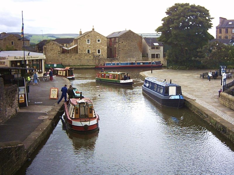 Narrowboats moored in the canal basin in Skipton town centre
