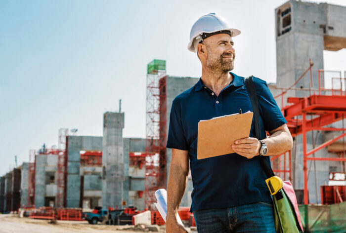 Civil engineer and construction worker manager holding digital tablet